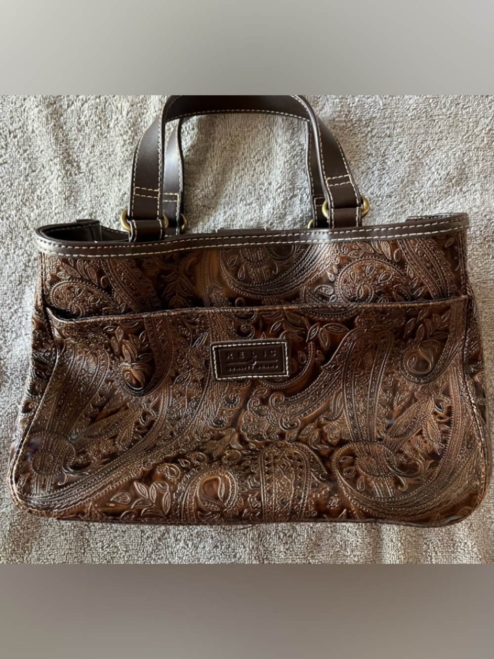 Embossed Brown Purse with 2 handles by Relic Brand, used in good condition.